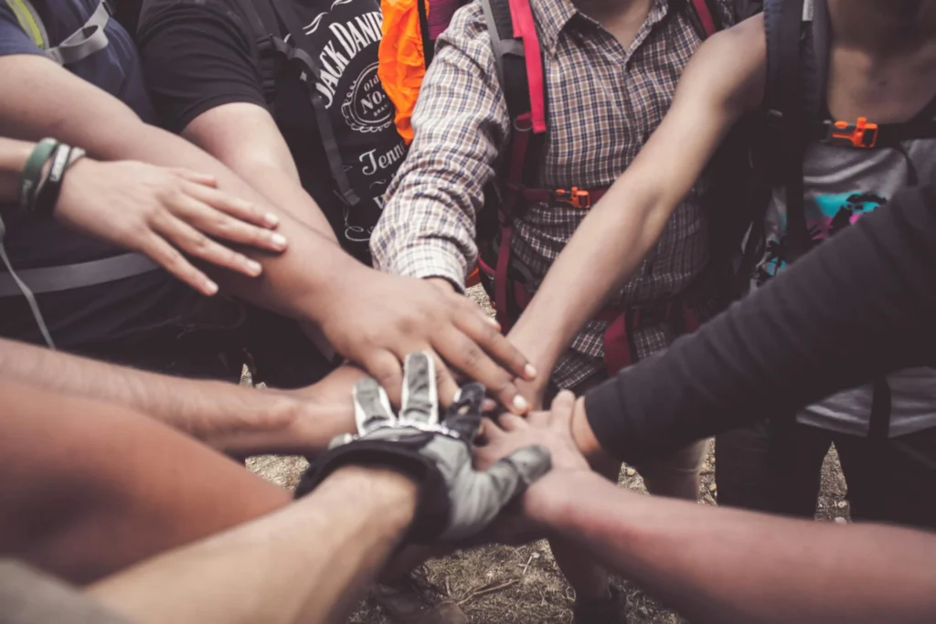 Group of people with hands together in center of circle